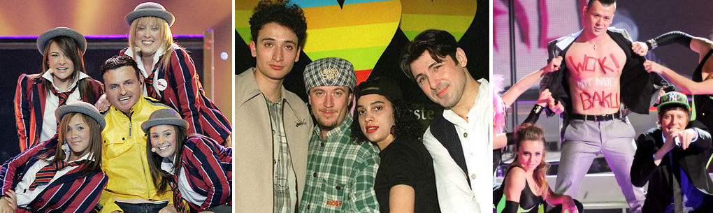A crowd posing in front of a stage.