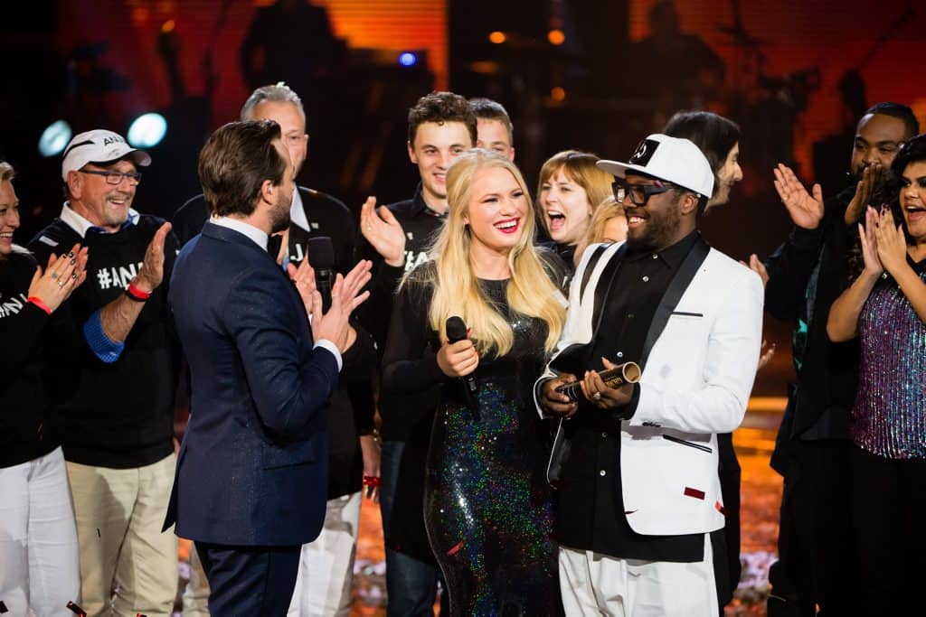 A group of people standing next to each other on stage.