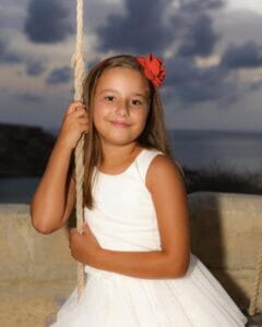 Young girl, white dress, swing.