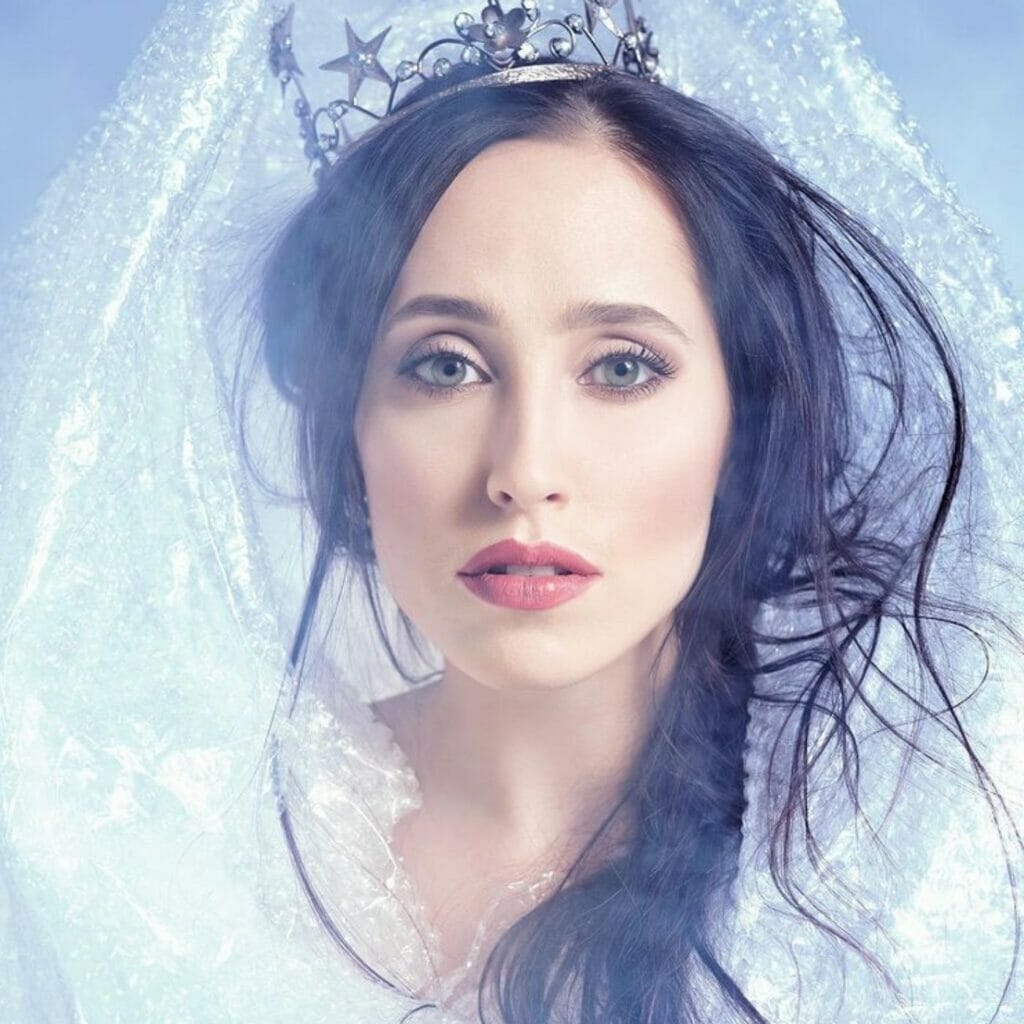 A woman donning a white dress and tiara.